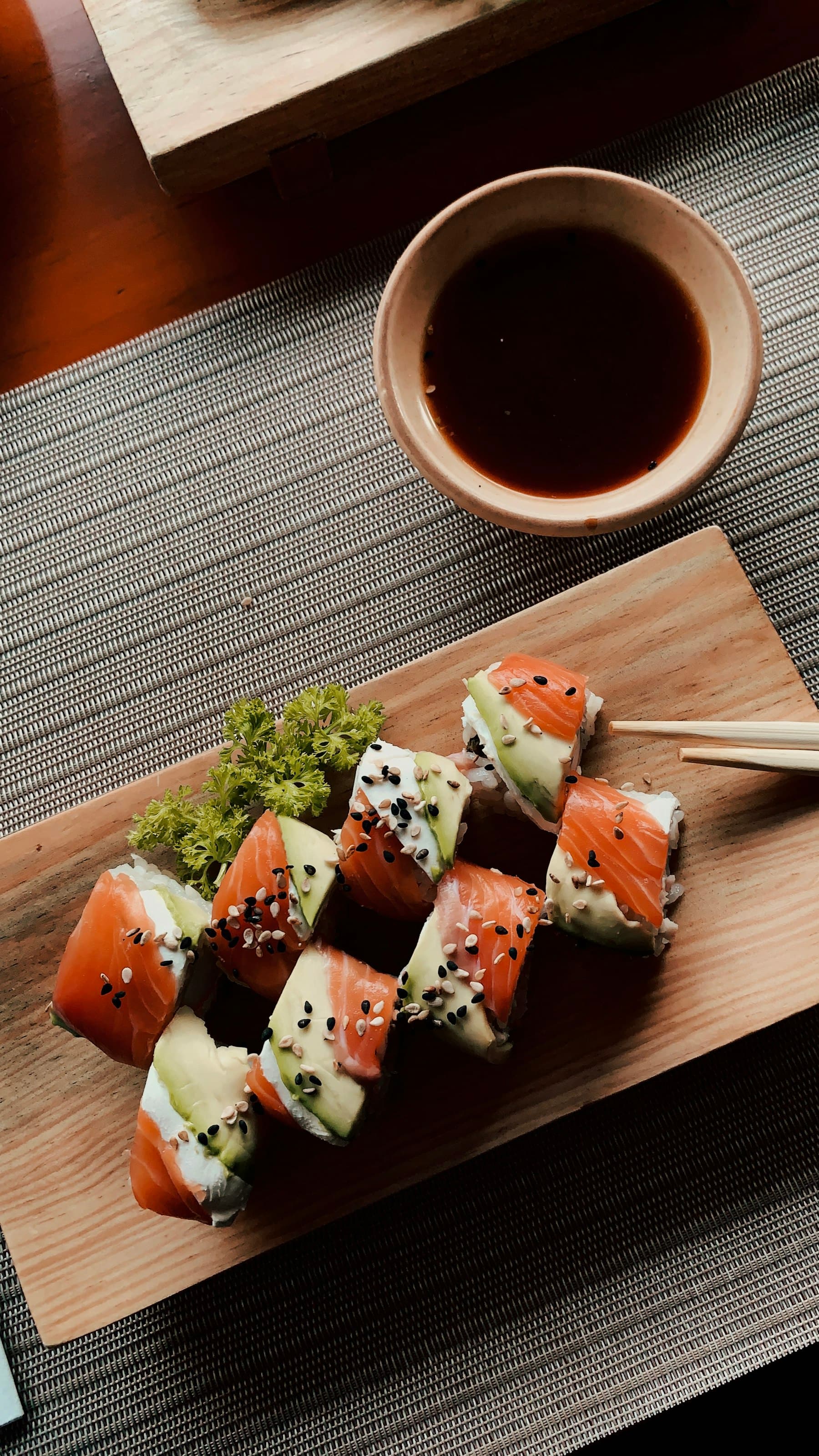 An assortment of nigiri on a dark slate