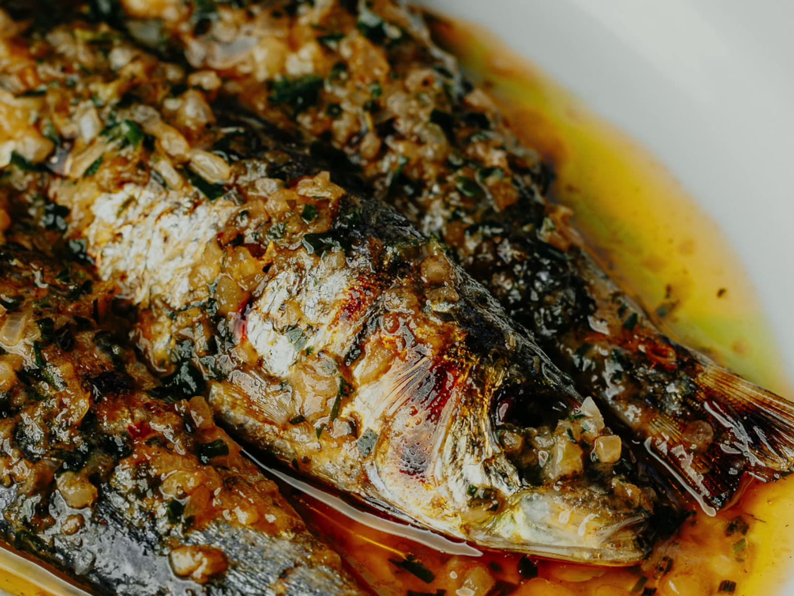 A whole fish roasted at Eleven Fifty Five, glazed in a herb, chilli and garlic butter sauce